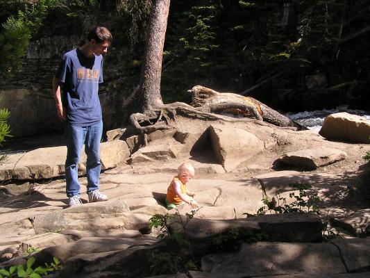 Noah plays on the rocks at the top of the falls.