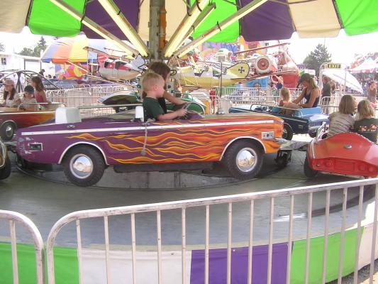 Andrea  and Noah in a firey convertable at the fair.