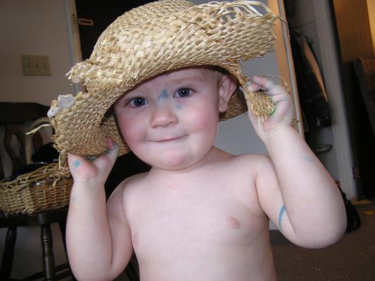 Noah wears an old straw hat.
