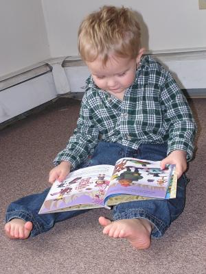 Noah reads Rudolf the Red Nosed Raindeer.