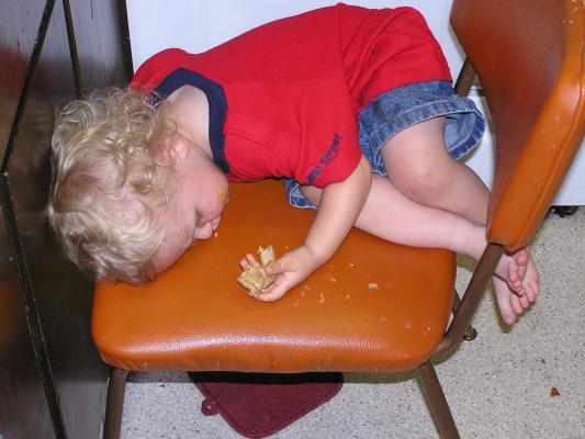 Noah fell asleep on a chair.