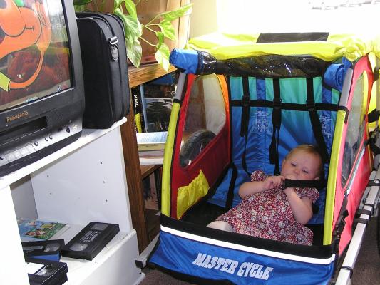 Sarah watches TV from the Bike trailer.