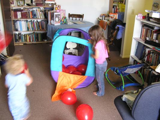 Noah and Andrea play with balloons.