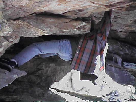 Jim hangs from a rock.