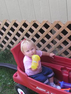 Sarah plays in the wagon.