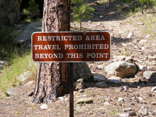 Restricted Area travel prohibited beyond this point.