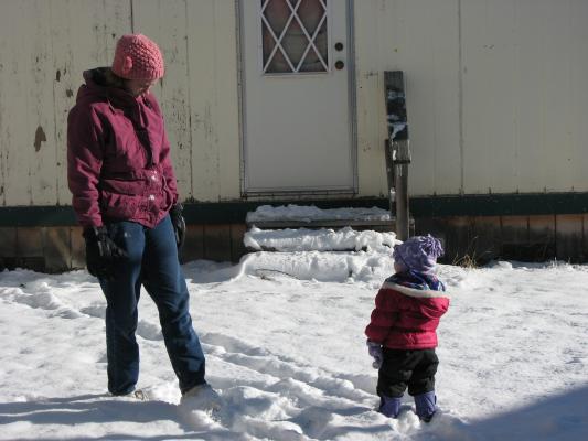 Katie and Sarah play outside in the snow.