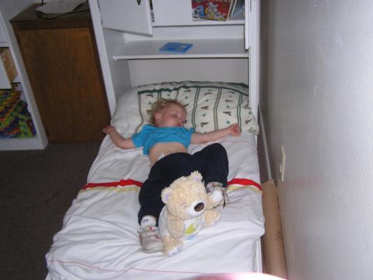 Noah sleeps in his bed.