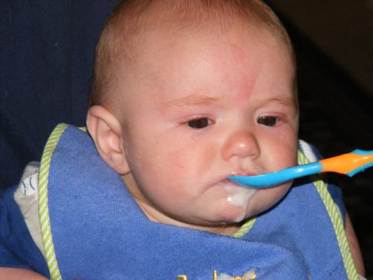 Joshua eats rice cereal