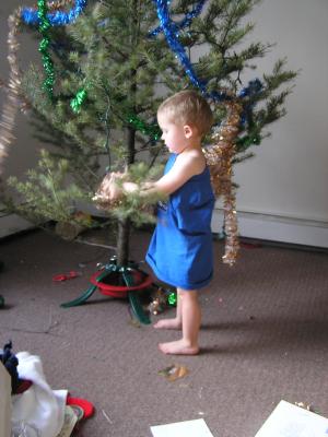 Noah helps decorate the tree.