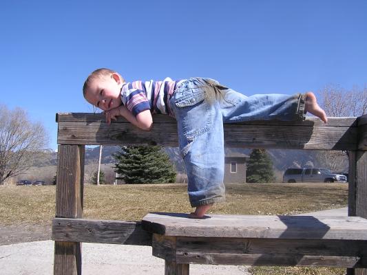 Noah plays on the rail.