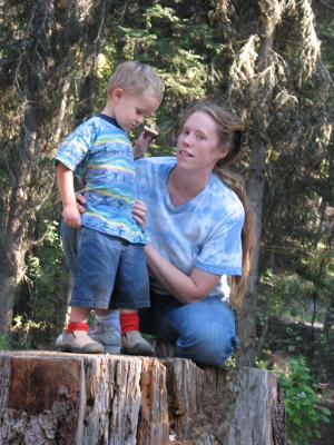 Noah and Katie on a stump at camp