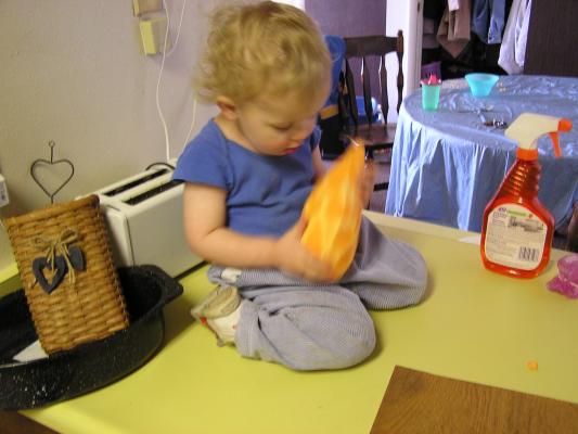 Noah plays with the big sweet potato.