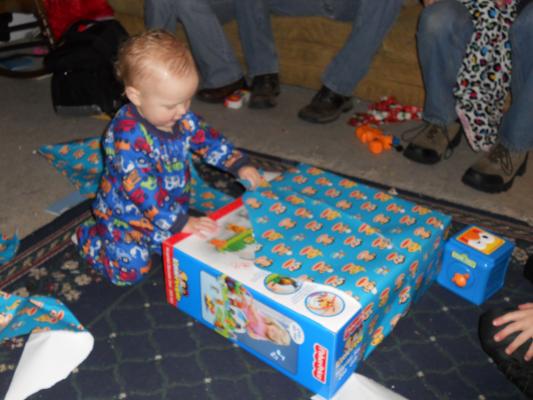 Joshua opens a birthday gift. 