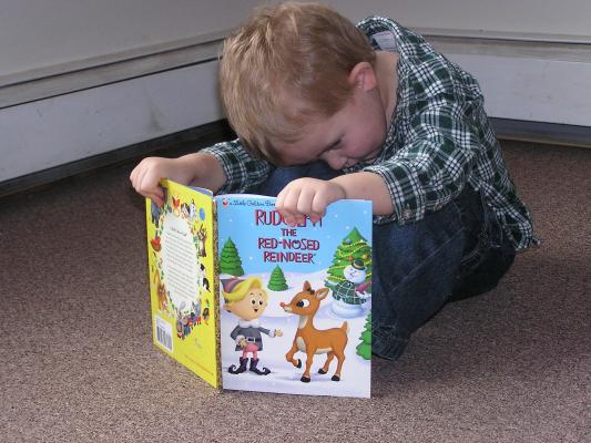 Noah reads Rudolf the Red Nosed Raindeer.