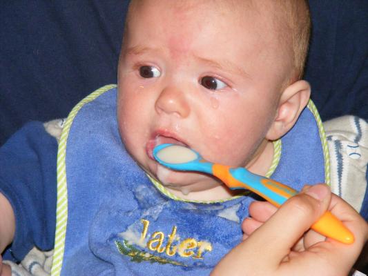 Joshua eats rice cereal