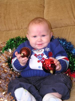 Sarah is holding Two Christmas balls