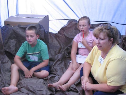 Jackson and Breanna and Kim in the story tent.