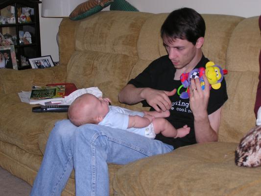Noah watches the monkey on David's lap.