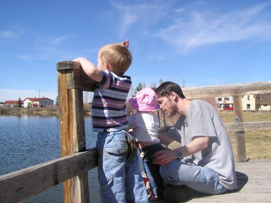 Noah throws rocks off the dock.