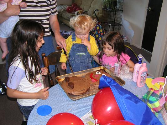 Katie cuts the chocolate bear's head off.