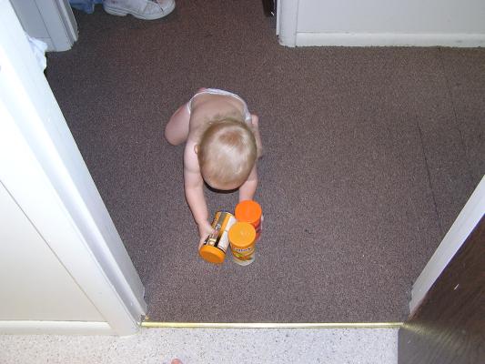 Noah plays with the fish food.