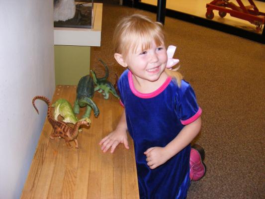 Sarah plays with dinosaurs at the Museum of the rockies free day.