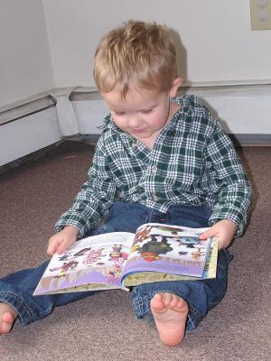 Noah reads Rudolf the Red Nosed Raindeer.