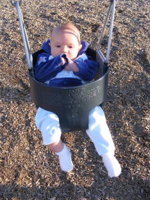 Joshua's first time in a park swing.
