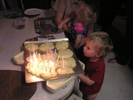 Noah helps blow out Katie's candles