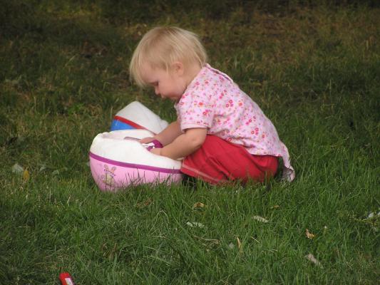 Sarah likes to play with the bike helmets, but  not to wear them.