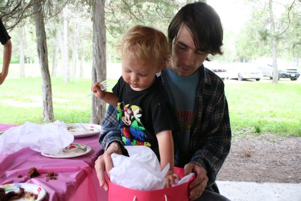 Noah opens his birthday present from Robert's family.