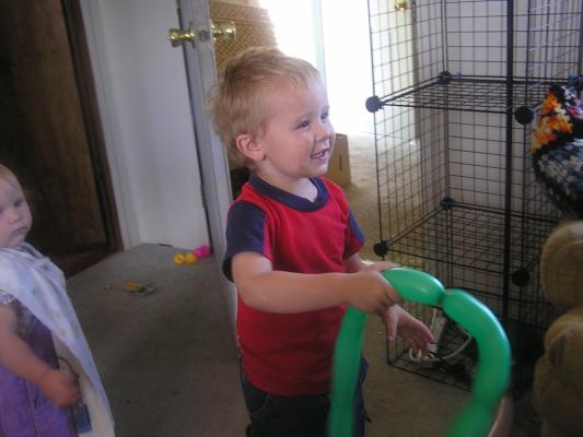 Noah plays with baloons on his birthday