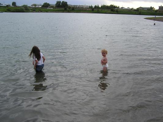 Malia, Andrea, and Noah play in the lake.