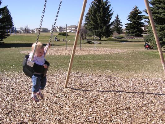 Sarah swings at the park.