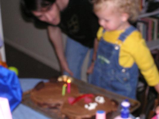 Noah is considering blowing out the candles.
