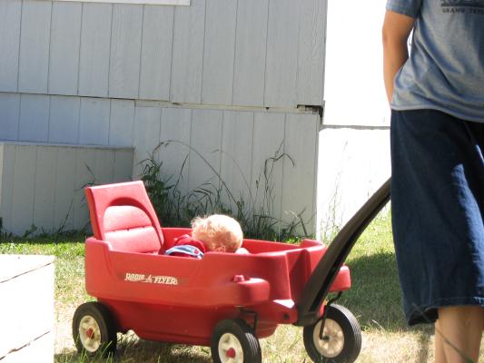 Katie pulls Sarah in the wagon