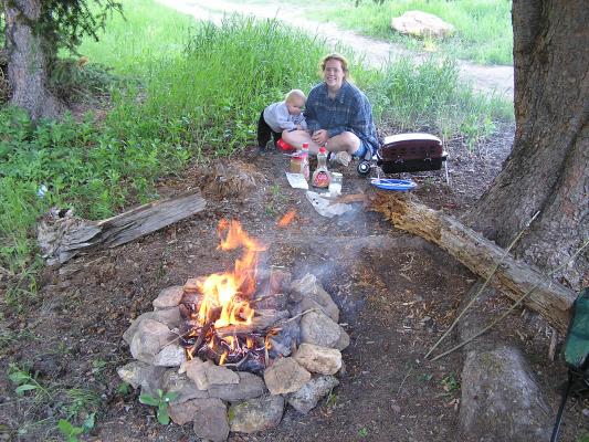 Mommy's cooking pancakes on the propane grill instead of the campfire.