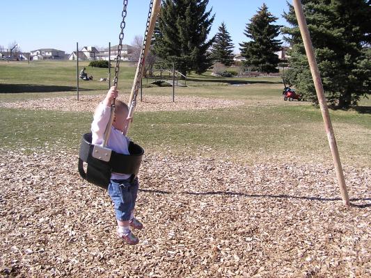 Sarah swings at the park.