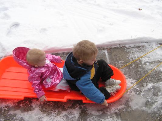 Noah and Sarah ride in the sled.