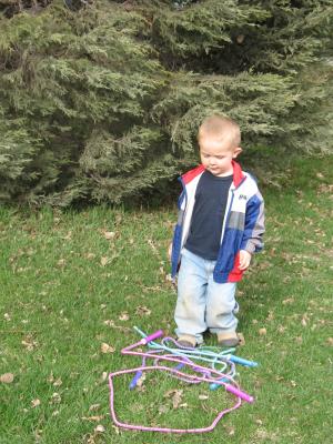 Noah plays with the jumpropes.