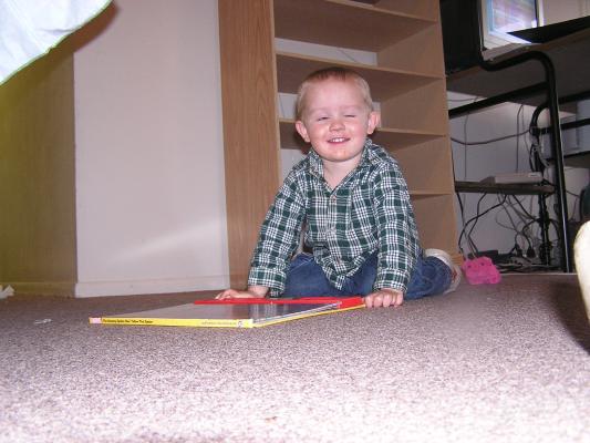 Noah loves his new noisy Spiderman book.