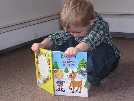 Noah reads Rudolf the Red Nosed Raindeer.