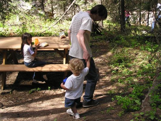 Noah walks down to the picnic table.