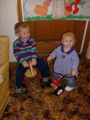 Noah and Sarah ride the ridding toys