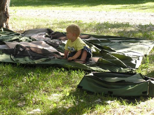 Noah helps with the tent poles.