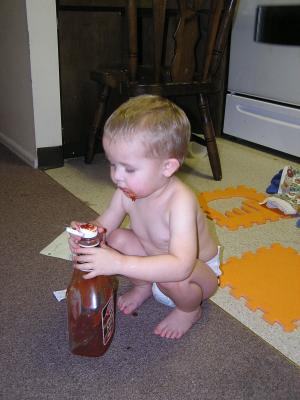 Noah found some ketchup packets. 
He thinks they should go into the ketchup bottel. 
Here are his attempts to ge them in there.
