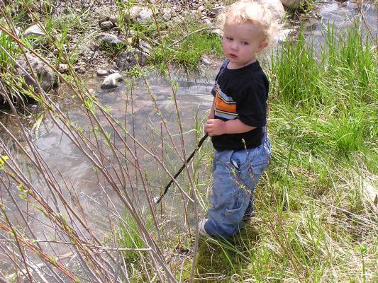 Noah stirs with his stick.