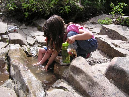 Andrea and Noah play in the little puddles.