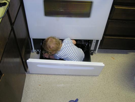 Noah plays in the stove.